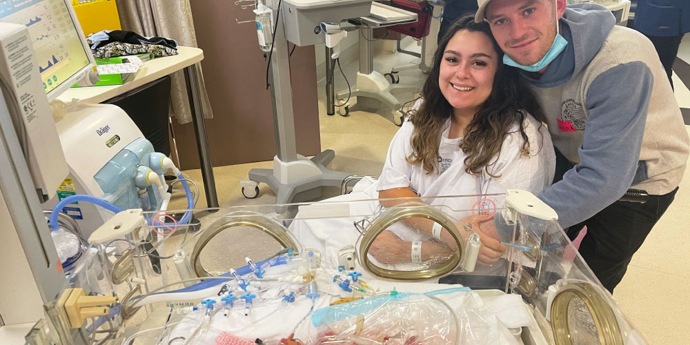 Sky and Trisdan with baby Remi in the Women’s NICU before the twins passed away.