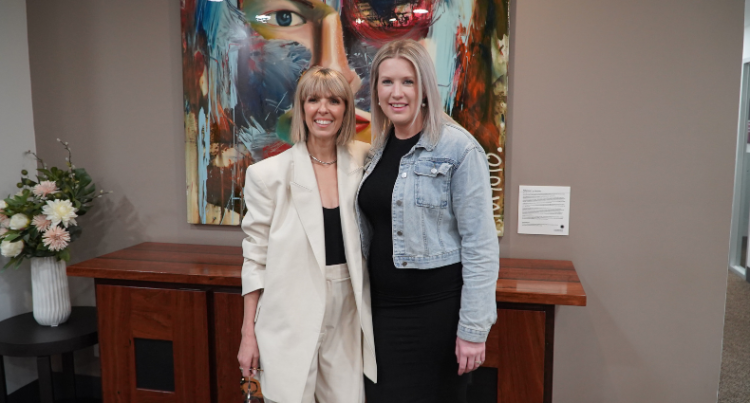 Two women, Nina Grillo and Cassandra Stephens, standing together, smiling.