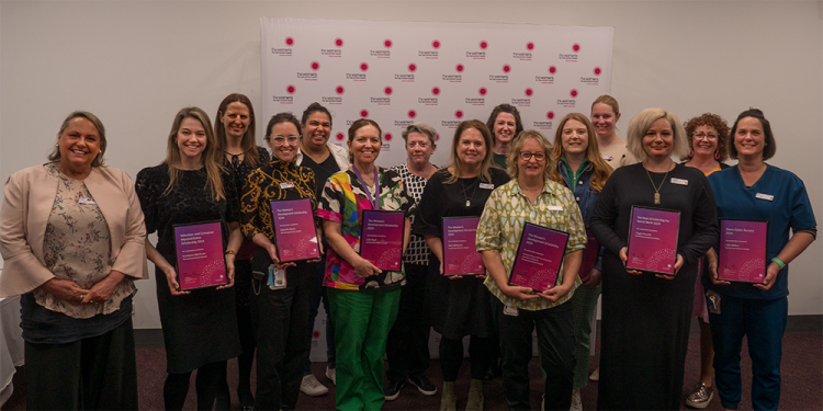 Group of award recipients holding their certificates.