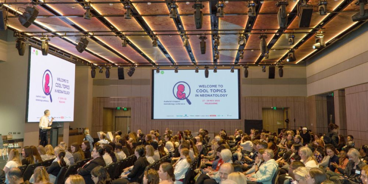 Cool Topics conference with room full of people listening to presenter. 