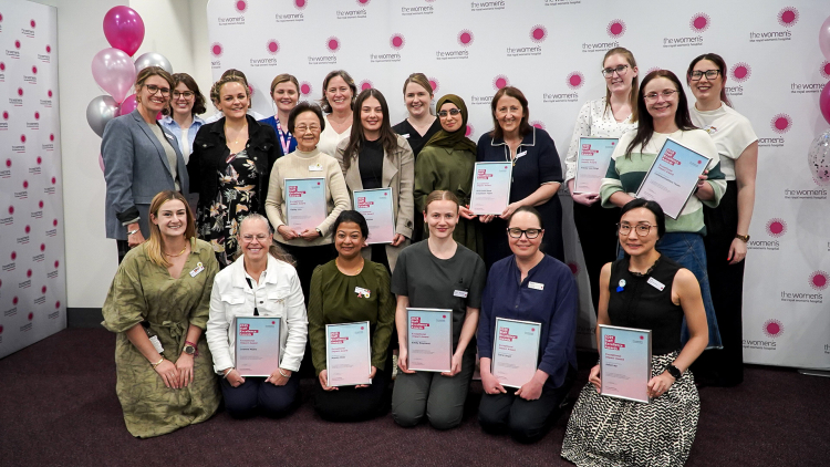 Recipients of the 2025 Exceptional Impact Award stand with their certificates.